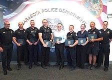 SPD Chief Rex Troche (left) and Deputy Chief Scott Mayforth (right) with (from left) Lt. Andrew Combs, Officer Nate Lynn, Officer Nick Bruno, Officer Ridge Collins, Officer Brenton Bieker, Det. Laura Bobitz and Officer Tim Dederick. They and others were involved in stopping a suicide threat on the Ringling Bridge.