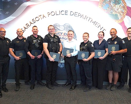 SPD Chief Rex Troche (left) and Deputy Chief Scott Mayforth (right) with (from left) Lt. Andrew Combs, Officer Nate Lynn, Officer Nick Bruno, Officer Ridge Collins, Officer Brenton Bieker, Det. Laura Bobitz and Officer Tim Dederick. They and others were involved in stopping a suicide threat on the Ringling Bridge.