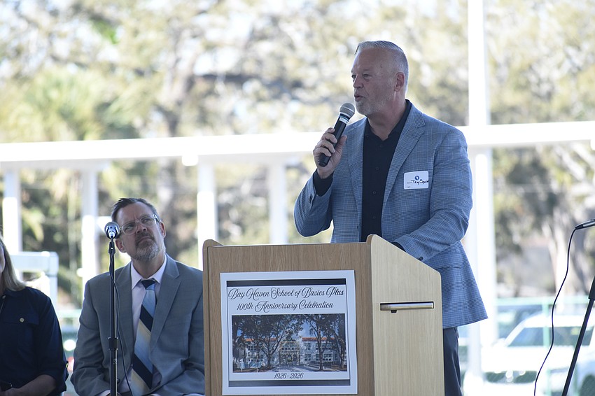 Principal Chad Erickson listens as former Principal Roy Sprinkle (2004-2007) speaks to attendees.