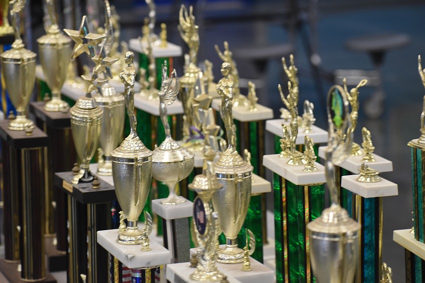 Sports trophies are set out on a table in the cafeteria.