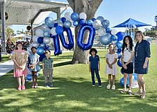 The winners of an essay contest had the chance to read out their essays during the event, and they included fourth grader Lorelei Martin, second grader Olivia Batista, kindergartener Logan Hernandez, third grader Petronius Boles, first grader Jade Rivers and fifth grader Amara Berry, pictured here with Assistant Principal Jennifer Kahler.