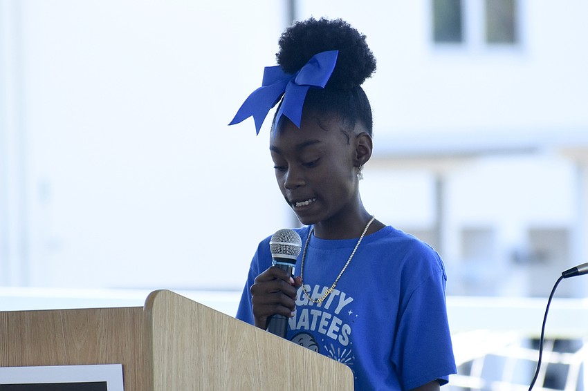 Fifth grader Kaitlyn Presha welcomes attendees.