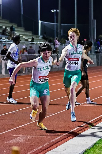 FPC's Michael Najpaver (2444) hands the baton to anchor leg runner Will Roberts in the 4x400 at FPC's East Coast Classic on Feb. 20. They both will be competing in the open 400 and the 4x400 at regional. Photo by Keishia McLendon