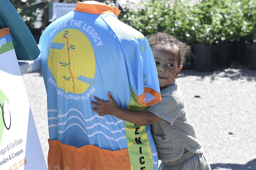 Josiah Adamo, 1, made a friend in a Friends of the Legacy Trail shirt.