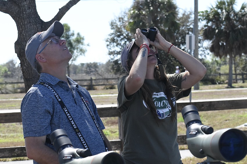 Jeff Bouton and Mariah Hryniewich of Kowa Sporting Optics look at the birds.