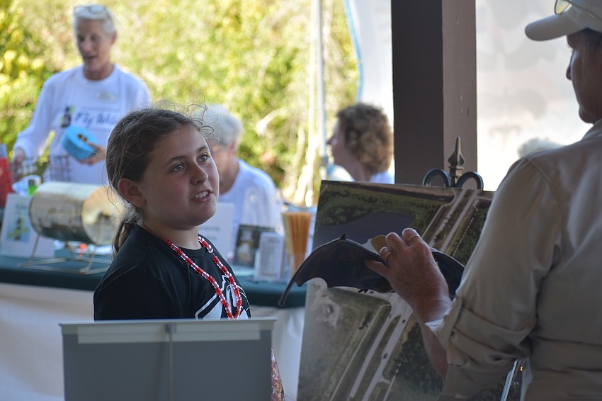 Margot Reisinger, 9, talks with Dawn Lansing of Big Waters Land Trust.