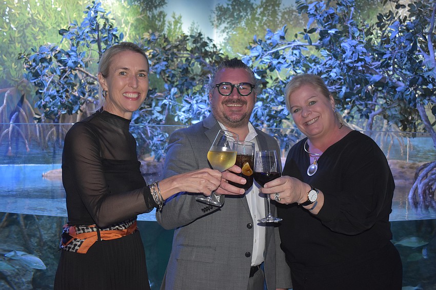 Women's Resource Center director of philanthropy Gray Videnka, director of client services Brent Giangregorio and CEO Ashley Brown celebrate the support they are to receive from the University Park Women's Club.