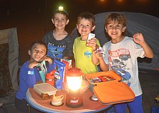 Nicholas Quintero, Conner King, Greyson Alexander and Lucas Matallana are campout ready with snacks, a lantern and even a headlamp.