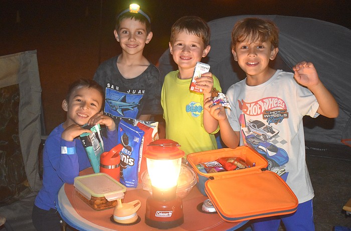 Nicholas Quintero, Conner King, Greyson Alexander and Lucas Matallana are campout ready with snacks, a lantern and even a headlamp.