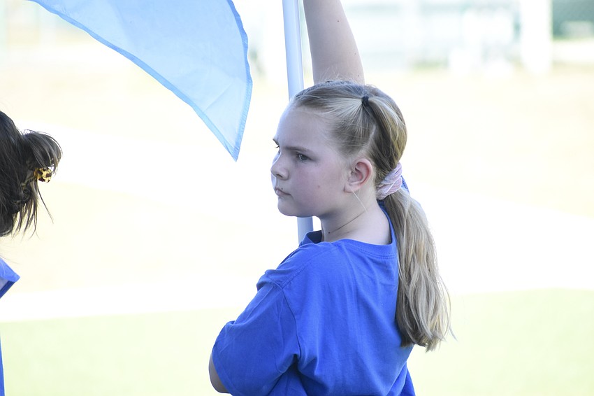 Third grader Noella Noonan of the Bay Haven Color Guard prepares for a performance.