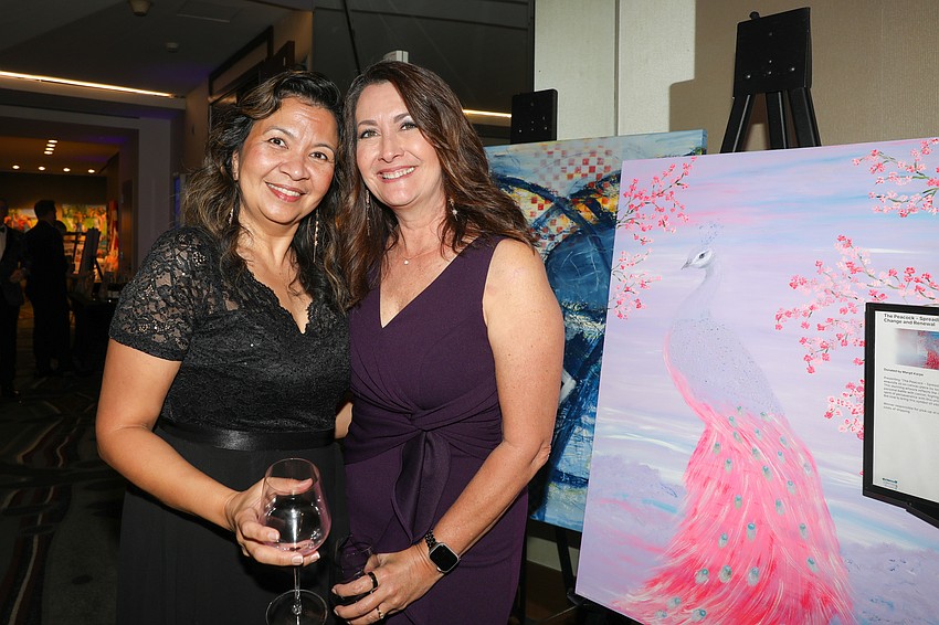 Jade Valencia and Sonya Miller peruse the gift basket items.