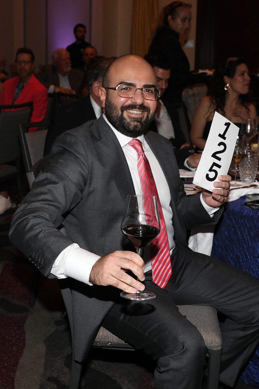 Dr. Ahed Roumia from Sarasota Memorial Hospital takes home the highly coveted Lipstick Lexi painting.