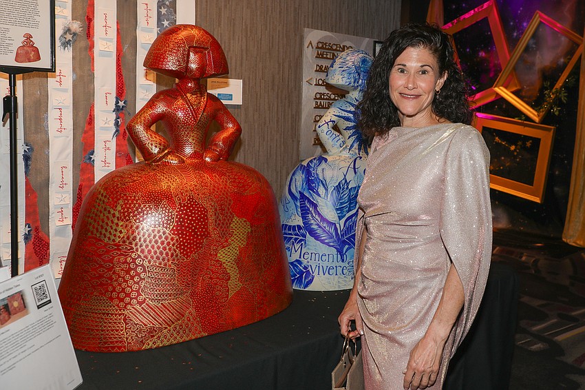 Debra Gill enjoys the donated art in the silent auction.