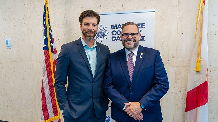 John Taylor, sales manager at Ralph Taylor's Nurseries, meets Rep. Bill Conerly.