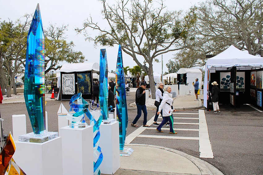 As soon as a brief downpour passed, Longboat Key art aficionados were back out exploring the second day of the Festival of the Arts at the Town Center Green, passing by sculptures by Bradenton-based artist Will Grant.