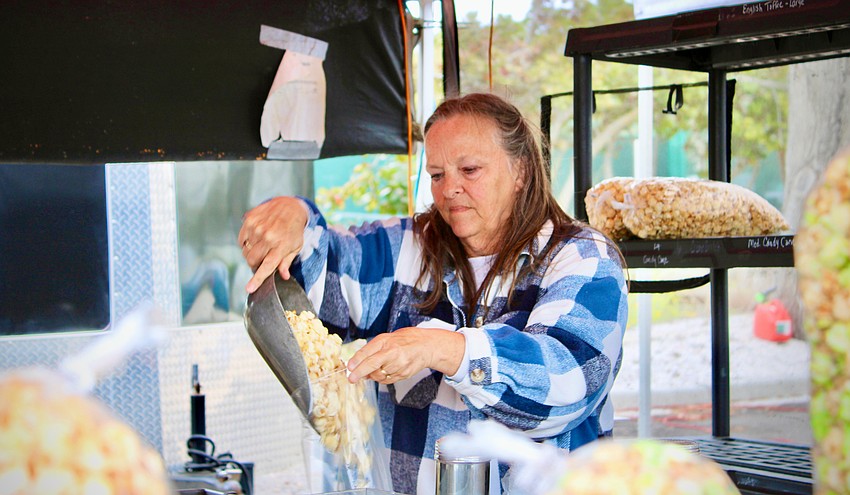Julie Cooper, who ran The Copper Kettle booth at last weekend's Longboat Key art festival with Jeff Cooper, said the freshly popped kettle corn was a greatly appreciated warm treat for many visitors.