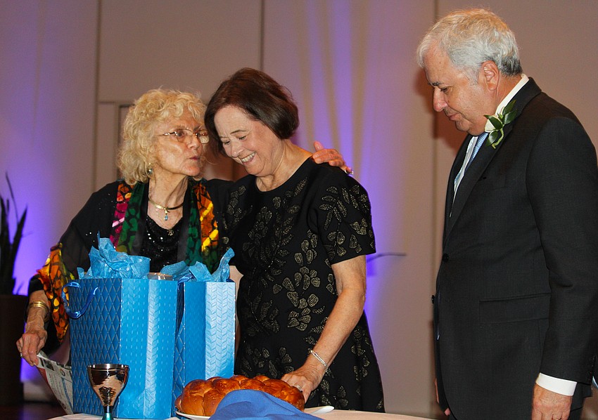 Suzan and Barry Friedman accept a token of the Temple Beth Israel community's gratitude for the family's years of support, presented by TBI president Lois Barson.