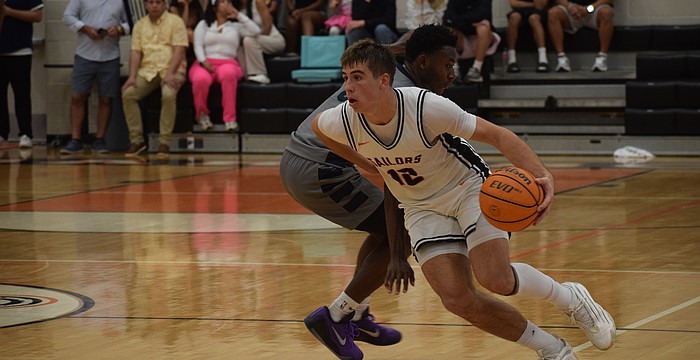 Johnny Lackaff slips by an opponent during the FHSAA Class 7A-Region 3 semifinals Feb. 21 at Sarasota High School. Whether on the court or on the sidelines, he's consistently found a way to impact the game.