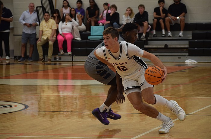 Johnny Lackaff slips by an opponent during the FHSAA Class 7A-Region 3 semifinals Feb. 21 at Sarasota High School. Whether on the court or on the sidelines, he's consistently found a way to impact the game.