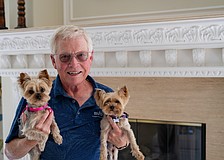 Longboat Key Mayor Ken Schneier holds Harriett (left) and Lizzie while posing for a picture in his Sabal Cove home Thursday, Feb. 19. After six years as mayor and eight on the Town Commission, Schneier has reached his term limit and will step down from the dais in March.