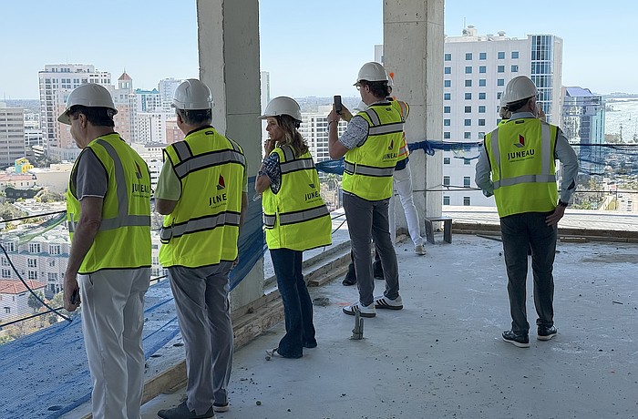 Real estate agents peer over a balcony on the 15th floor during a tour of the One Park condominium tower.