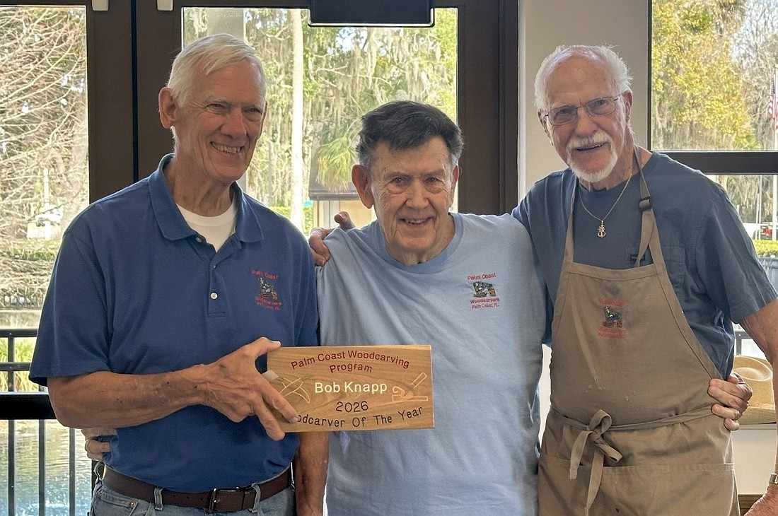 Jeff Kingdon, 2026 Woodcarver of the Year Bob Knapp and Howard Hawrey. Kingdon presents Knapp with a plaque. Courtesy photo