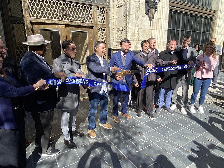 JWB Real Estate Capital President Alex Sifakis cuts the ribbon Feb. 20 at The Greenleaf building at 208 N. Laura St. in Downtown Jacksonville. The renovated building is the headquarters for JWB. From left are: Council members Ken Amaro and Raul Arias, Sifakis, Downtown Investment Authority board member Scott Wohlers, DIA CEO Colin Tarbert and city Executive Director of Economic Development Ed Randolph, along with others.
