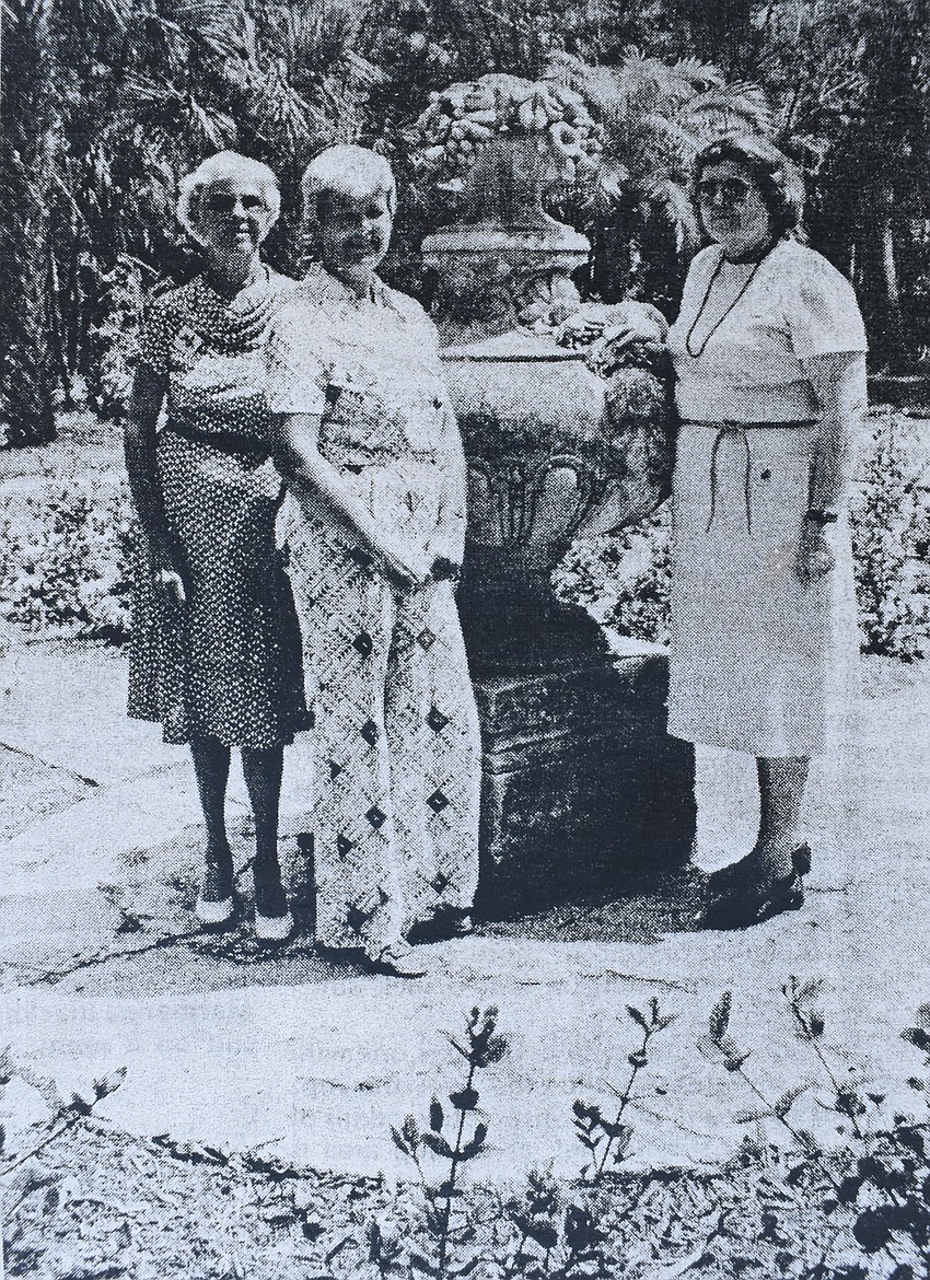 Margaret Snyder, Judith Scheider, president of Driftwood Garden Circle, and Merle Suave pose by the urn.
