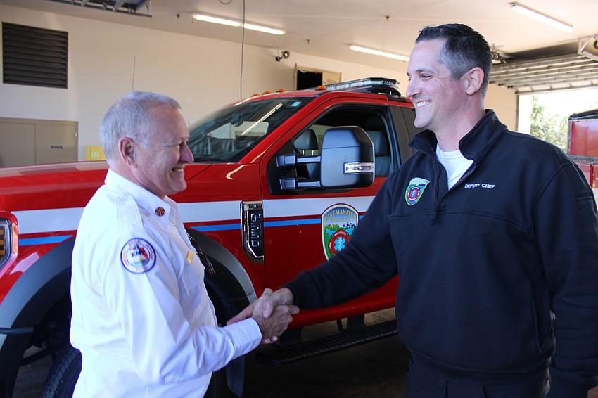Chief Lee Whitehurst congratulates Paul Wren after the deputy chief was named Whitehurst's successor starting in January, 2027.