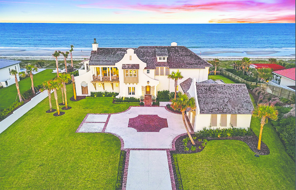 Oceanfront two-story home features four bedrooms, four full and two half-bathrooms, porches, balconies, patio, guest suite, elevator, wine cellar, outdoor kitchen, pergola and putting green.