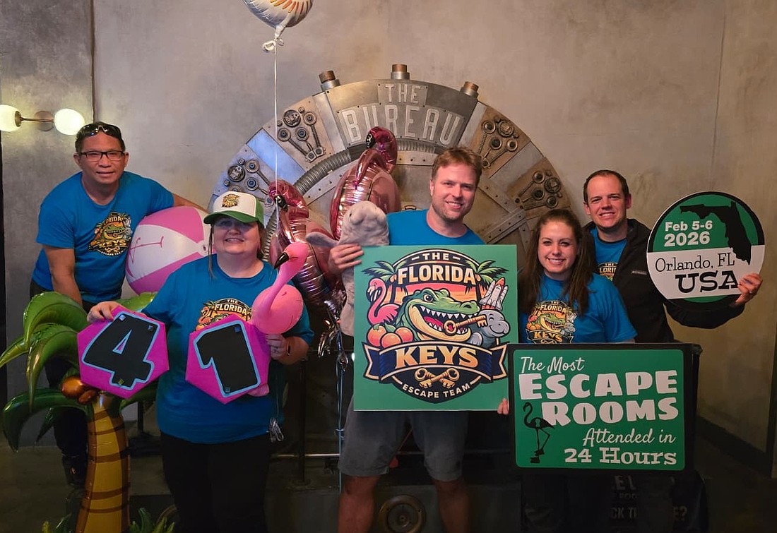 The team celebrated its accomplishment at The Bureau Escape Room once 41 rooms were completed.