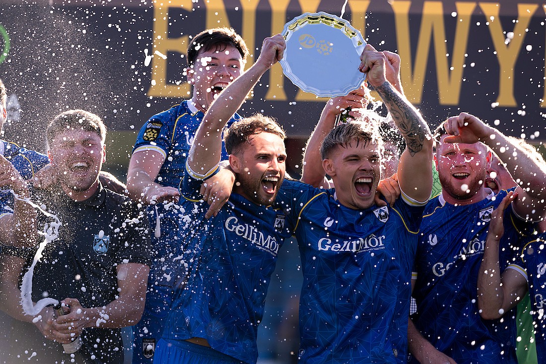 Haverfordwest County's Dylan Rees and Corey Shephard lift the trophy during the JD Cymru Premier 24/25 - European Play Off match between Haverfordwest County AFC and Caernarfon Town at Ogi Bridge Meadow Stadium in Haverfordwest on May 18.