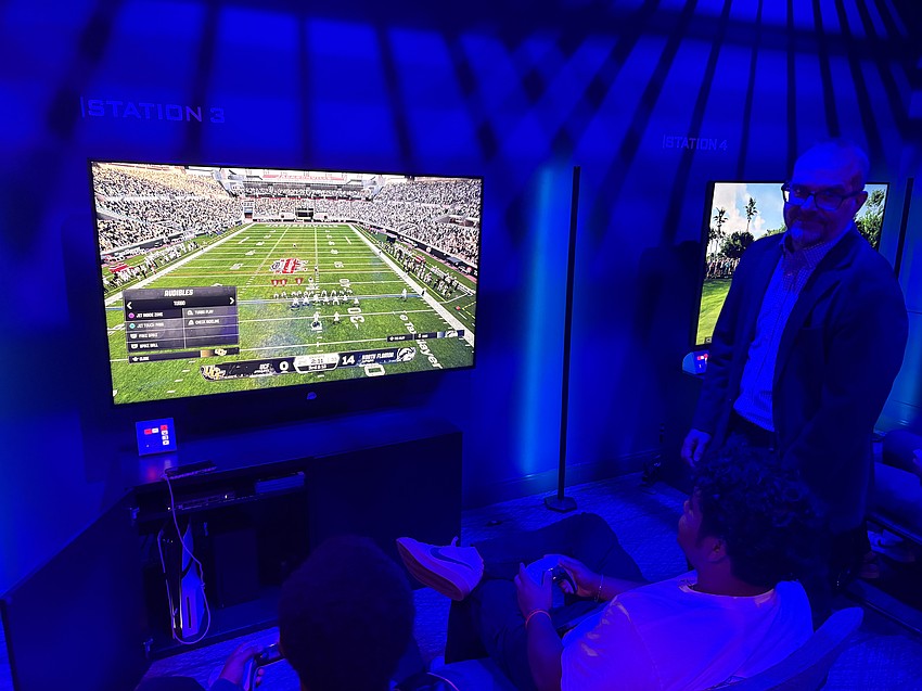 Two UNF students play EA Sports’ college football video game.
