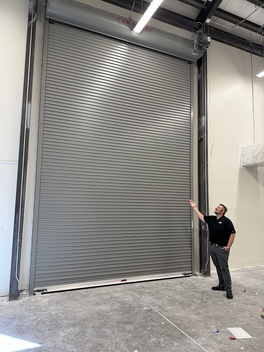 Pictured is the carpentry lab 2-story door. The operating staff offices are on one side of the building and the labs for hands-on construction training are on the other. The auditorium was strategically placed between the two to act as a noise buffer.