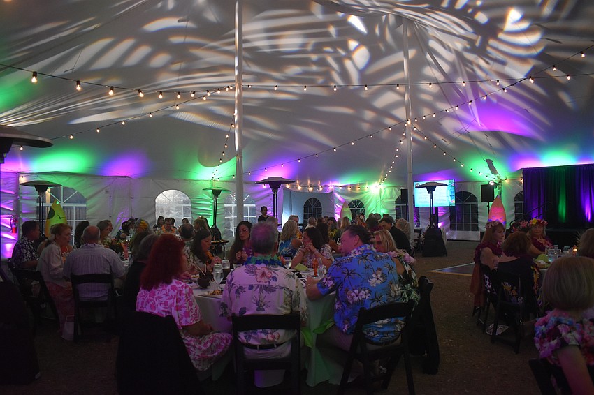 Attendees of the Tropical Escape fundraiser by Sisterhood for Good are able to come together and enjoy cocktail and hors d'oeuvres hour with live music, a seated dinner, fire and hula dancers and silent and live auctions.
