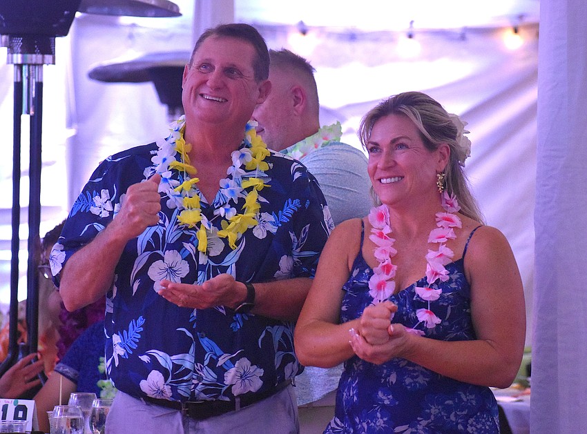 Myakka City's Jerry Dakin and Heather Koester, who are engaged, play a game of rock paper scissors as part of the Tropical Escape's fundraising.