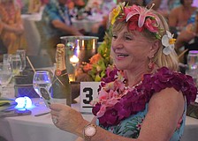University Park's Marilyn Kern reacts after making the winning bid during the live auction for a Hawaiian vacation at Sisterhood for Good's Tropical Escape Feb. 27 at the Sarasota Polo Club.