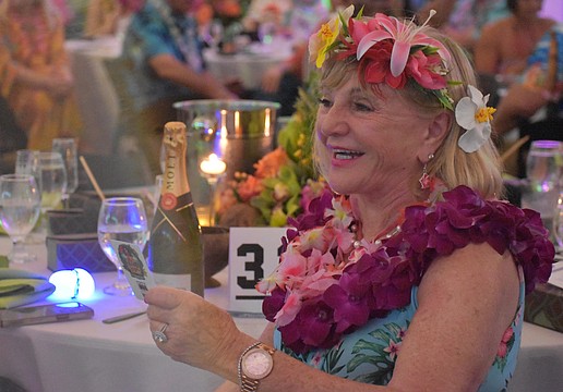 University Park's Marilyn Kern reacts after making the winning bid during the live auction for a Hawaiian vacation at Sisterhood for Good's Tropical Escape Feb. 27 at the Sarasota Polo Club.