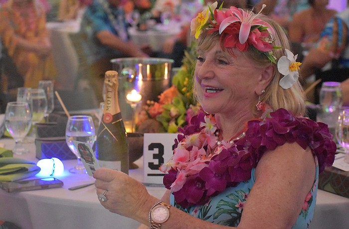 University Park's Marilyn Kern reacts after making the winning bid during the live auction for a Hawaiian vacation at Sisterhood for Good's Tropical Escape Feb. 27 at the Sarasota Polo Club.