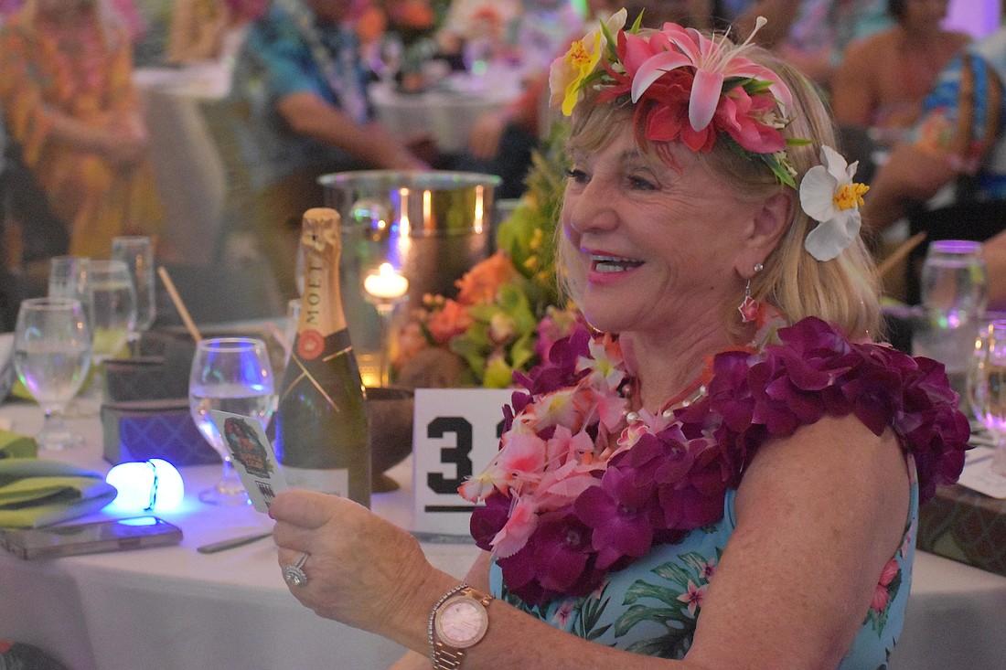 University Park's Marilyn Kern reacts after making the winning bid during the live auction for a Hawaiian vacation at Sisterhood for Good's Tropical Escape Feb. 27 at the Sarasota Polo Club.