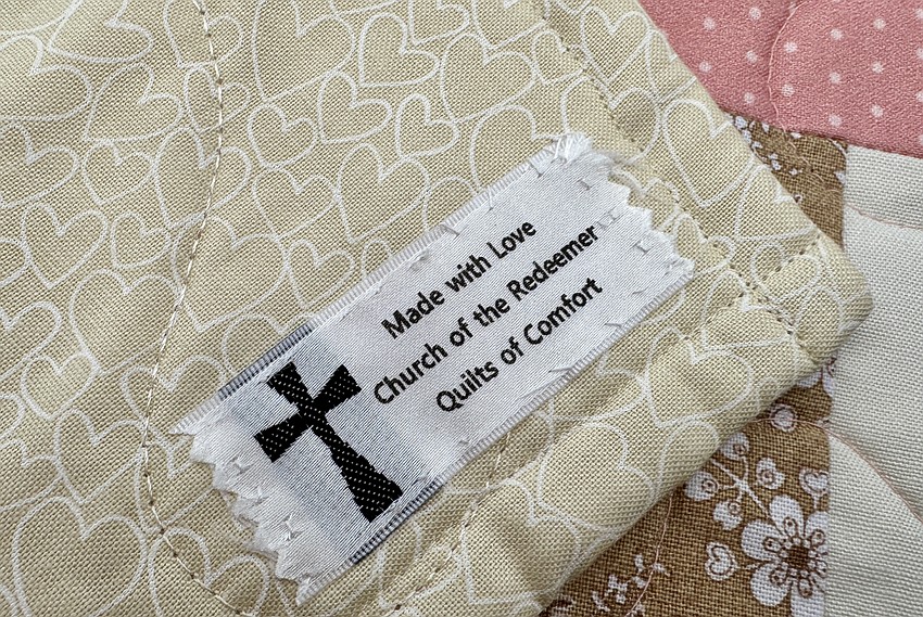 Each of the quilts made by Church of the Redeemer volunteers received a tag.