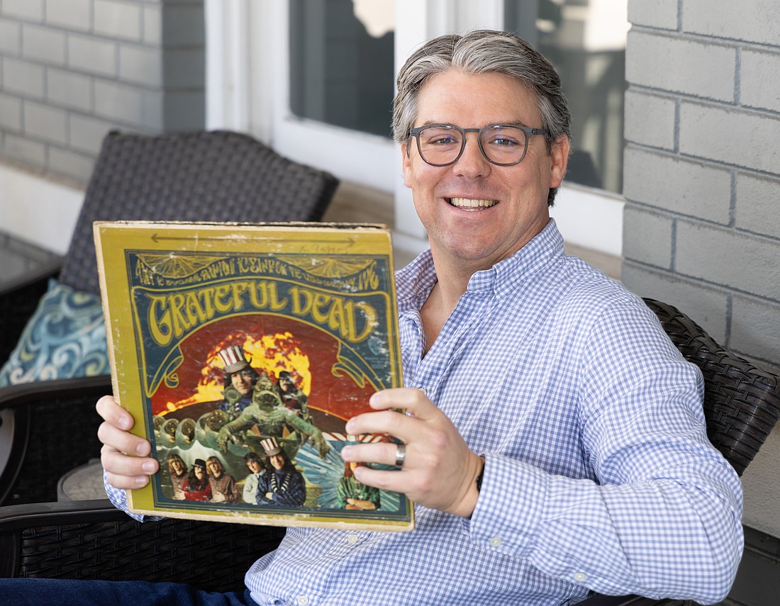 Kevin Caldwell, co-founder of Golden Road Advisors, poses with a Grateful Dead album.