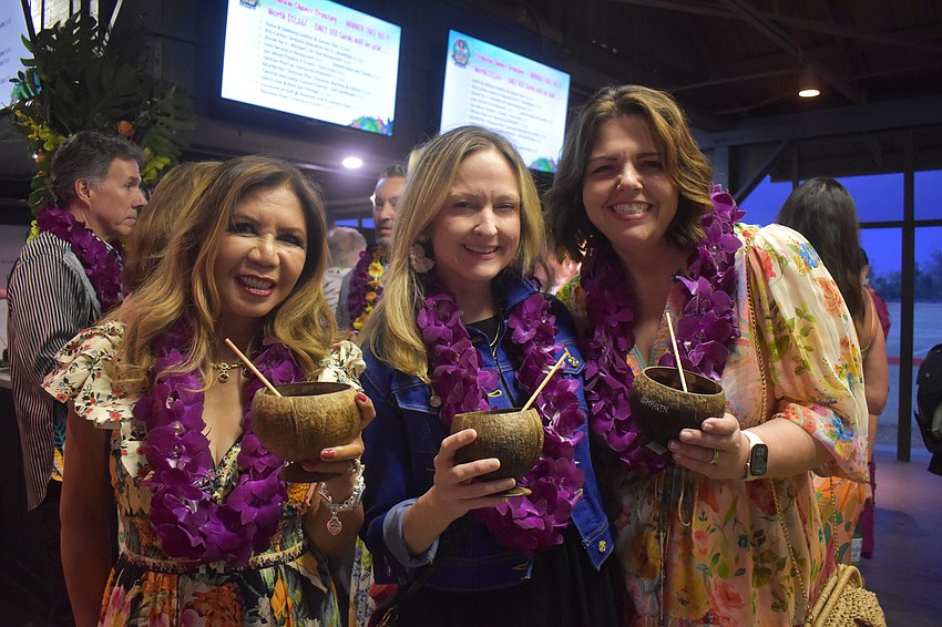 Evella Feldhackar, Erin Duggan and Monaca Onstad feel like they're on the beach with their mai tais in coconut-themed cups.