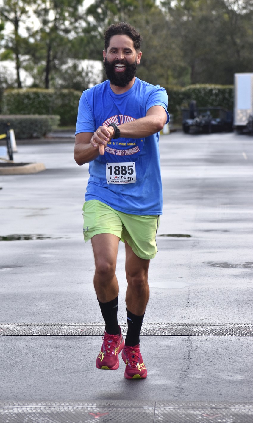 Sarasota's Eliezer Freitas crosses the finish line for the 5K.