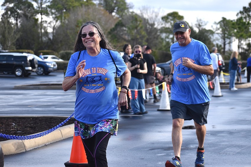 Sarasota's Luanne and Rick Lemke cross the finish line at the Suncoast Stars Community's second annual Stride to Thrive 5K.