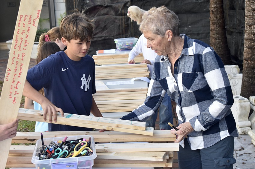 McLean Gaddy, 12, works with Kathy Hynes.