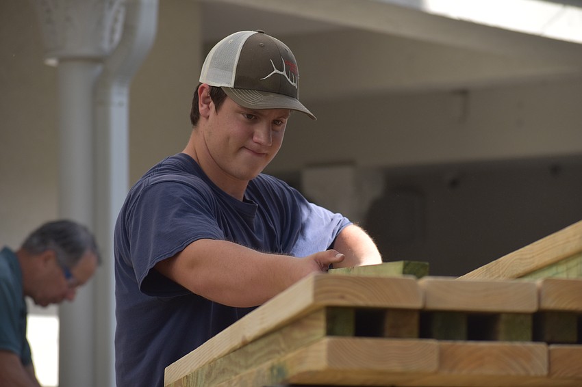 Gavin Kubisiak, 17, adds a finished piece to a stack.