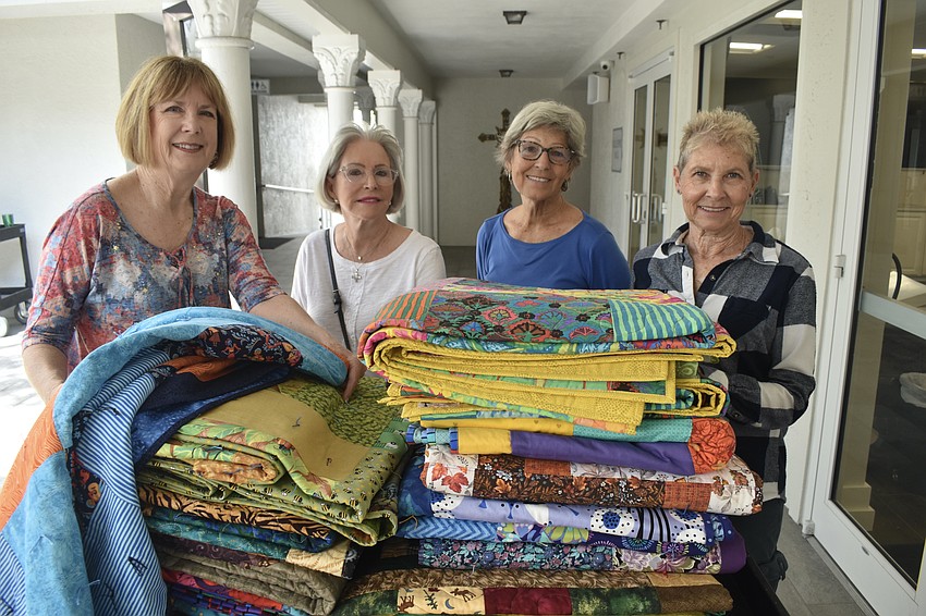 Janet Gallagher, Mary Jane Hartenstine, Lavonne Shedivy and Kathy Hynes were among those who knitted the quilts for the beds.