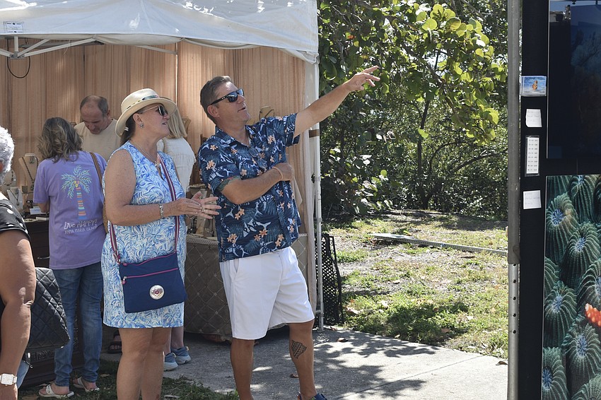 Karla Engel and her husband Fred Sowers discuss a piece of artwork.