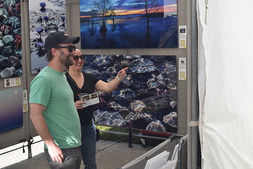 Ryan Fowler and his girlfriend Courtney Dietch browse photographs.